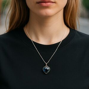 Black heart pendant set in silver